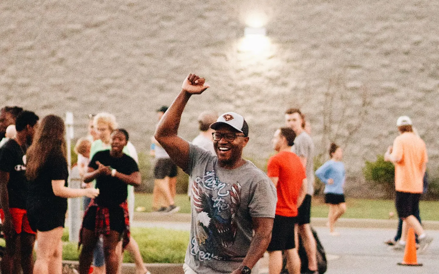 A player with a cornhole bag celebrating at a community gathering