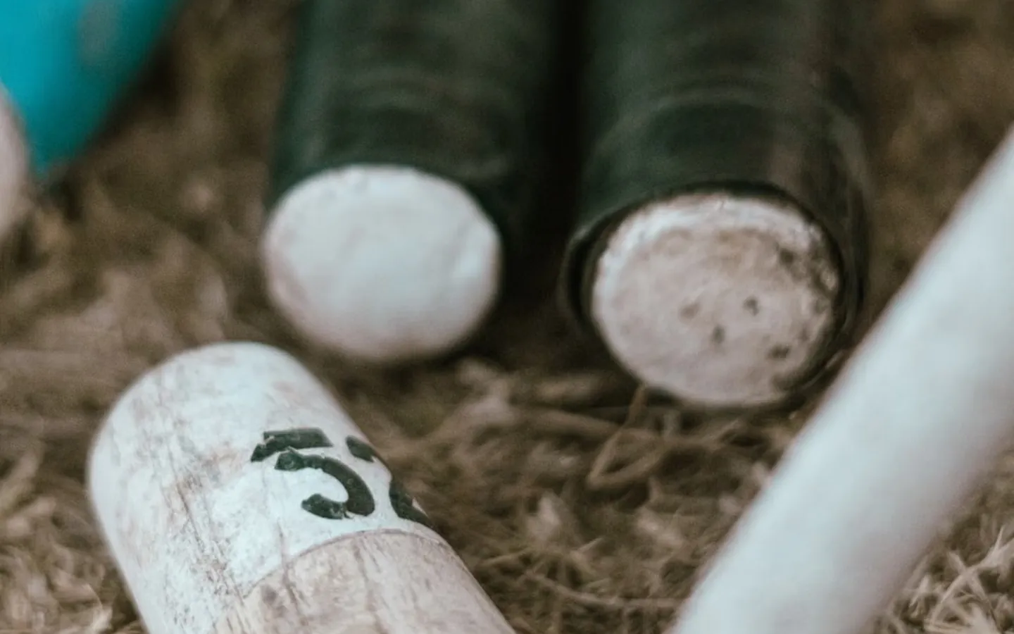 Wooden croquet mallets resting on grass