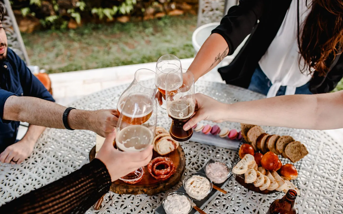 Friends raising their glasses around an outdoor table